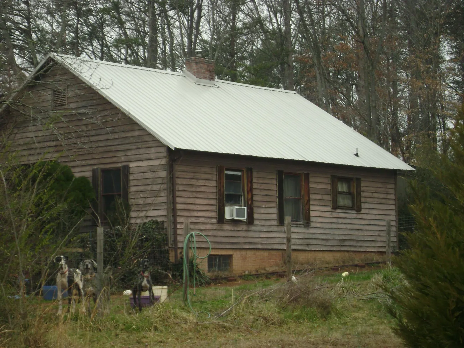White metal roof on an old wood sided farmhouse, from a Metal Roof Installation job in Kenneth