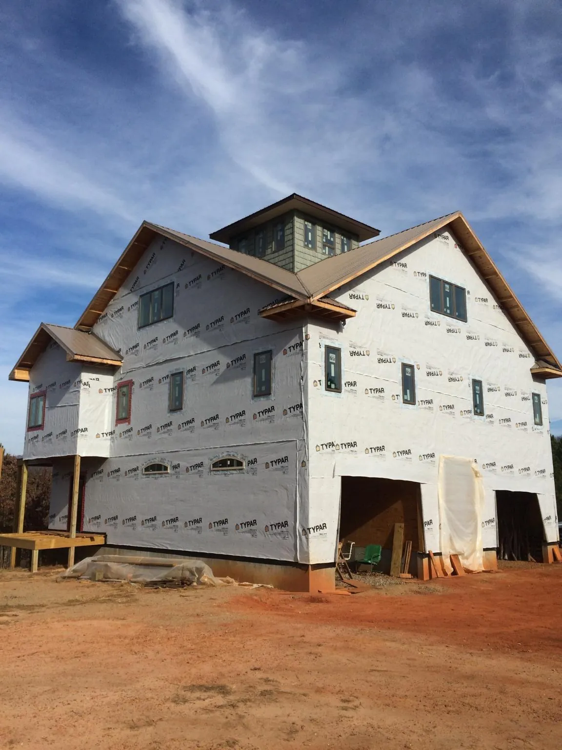 New two story house under construction with a cupola and gabled roofs in Kenneth